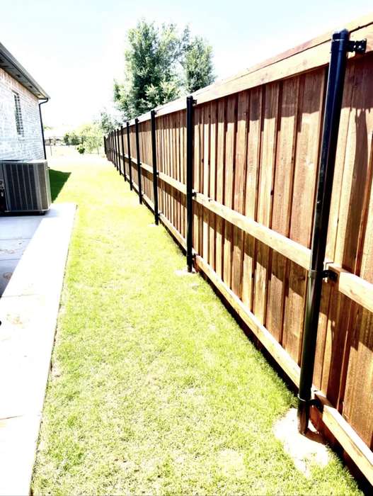 Stained cedar fence on steel posts